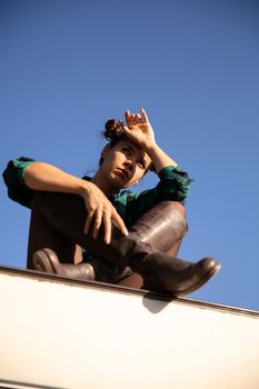 Young girl with serious faces on the roof of a retro camper. Recreation time