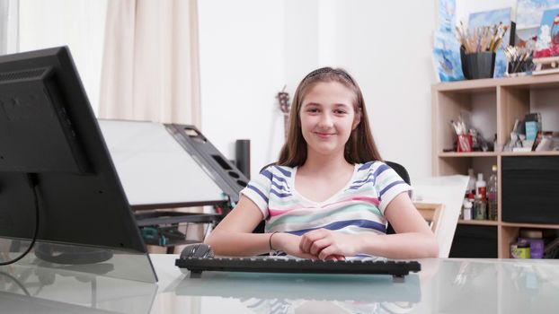 Slow motion portrait of a cute teenage girl smiling to the camera. Young girl is happy and joyful.