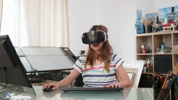 Teenage girl using a mouse a keyboard and a vr headset to play a game. Teen flying a spaceship virtually.
