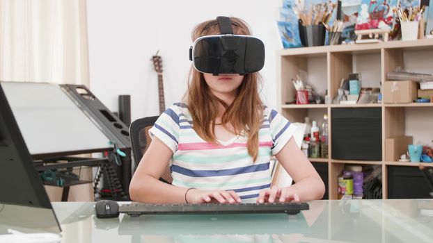 Teenage kid typing a text on her keyboard and wearing a vr headset. Teenage girl in her room playing a vr text game.