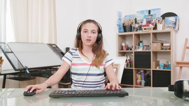 Passionate teenage female gamer losing and quiting. Girl gets mad after losing a game on the computer.