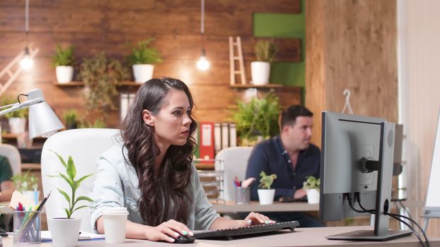 Female and male colleagues talking over a new project. They are working in a cozy office. Marketing team