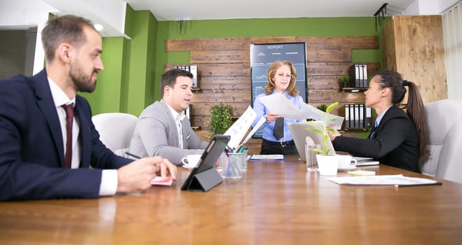 Caucasian businessman with tablet in a meeting in conference room.