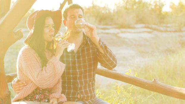 Wine tasting in a beautiful sun flares at the sunset.