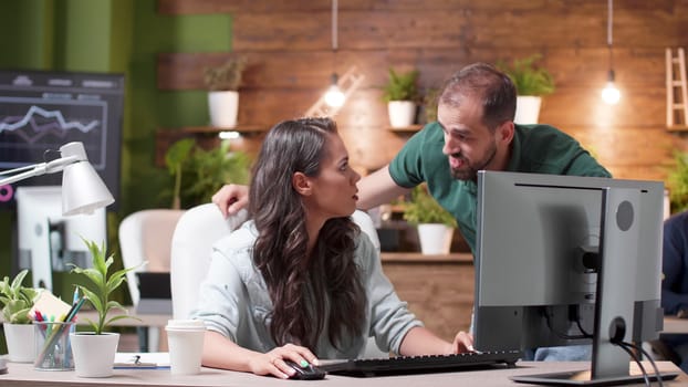 Manager talking with a worker about a new project in modern and cozy office