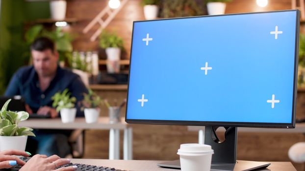 Close up footage of computer screen mock-up in a busy office