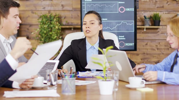 Investment team having a meeting in the conference room. Documents on the conference room.