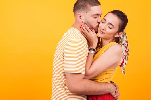 Close up portrait of handsome boyfriend kissing his attractive girlfriend. Relationship goals.