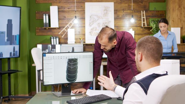 Construction engineers working on a heating turbine for business buildings. Computer screen.