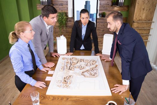 Top view of architects working together in conference room on a real estate project.