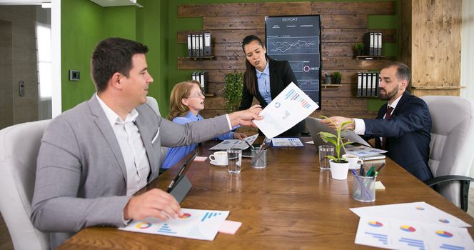 Businessmen working together and exchanging information in conference room.