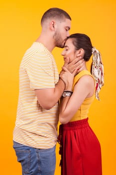 Handsome bearded boyfriend kissing his girlfriend forehead. Romantic couple.