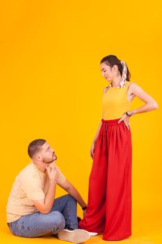 Attractive boyfriend looking up at his beautiful girl while smiling at him.