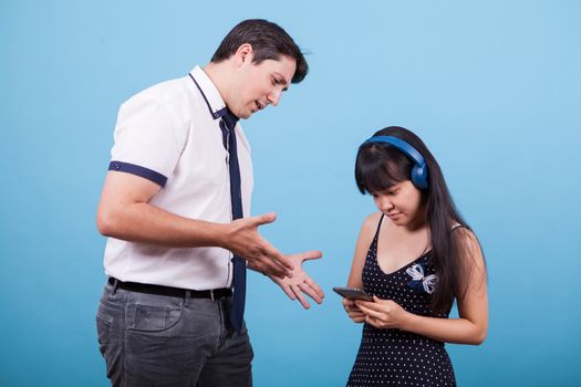 Asian girlfriend ingnoring her boyfriend while he's trying to talk with her. Interracial couple.