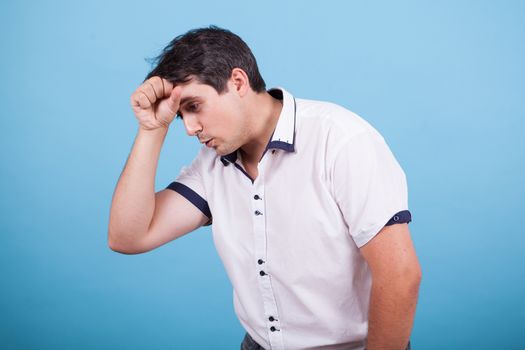 Caucasian thinking about a dilema with hand on his forehead. Hand gesture.