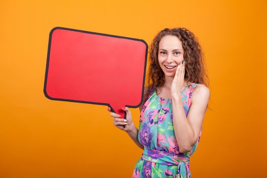 Portrait of excited woman holding an empty announcement placard. Gorgeous woman.
