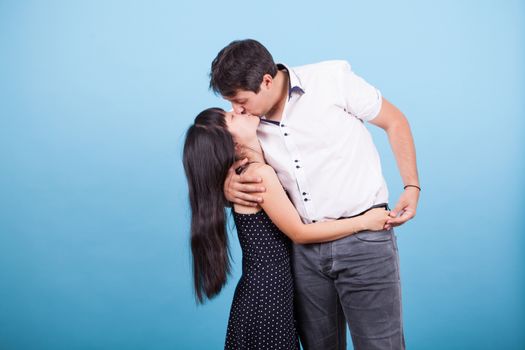 Caucasian man kissing his beautiful asian girlfriend. Interracial couple kissing.