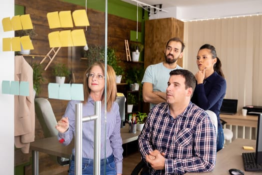 Four colleagues discuss some data from the projectin the modern office