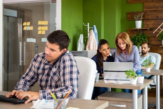 Busy creative agency office. People are working at their desk