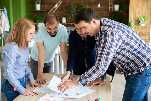 Employees explain to the manager their ideas about the project. Teamwork and strategy