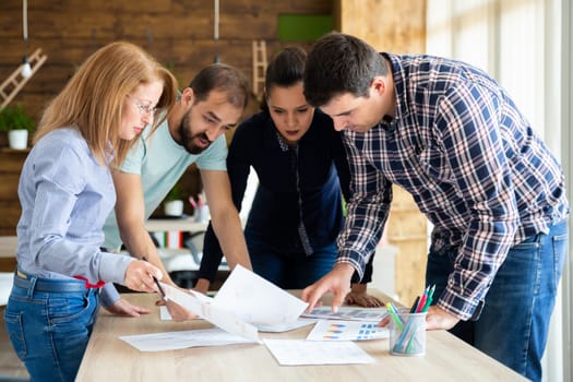 Start-up brainstorming meeting in modern office. Four people