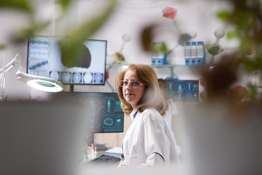 Portrait of middle age woman in a plant laboratory. Microbiological laboratory. Quality control.