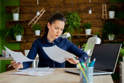 Brunette girl work in modern office.Start-up cozy office