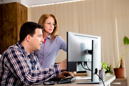 Creative team talking in the office. Business team in office working on new project