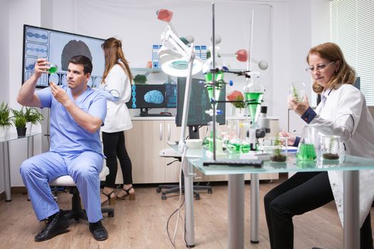 Research team of scientist working in microbiology laboratory. Quality control.