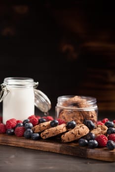 Delicious and organic chocolate chips ready to be eaten from a wooden plate. Tasty biscuits.