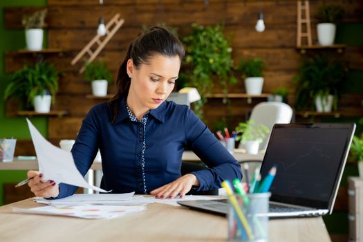 Businesswoman read the company report.Cozy office