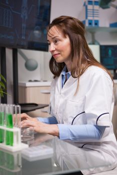 Portrait of focused female microbiology scientist in laboratory. Food inspection.