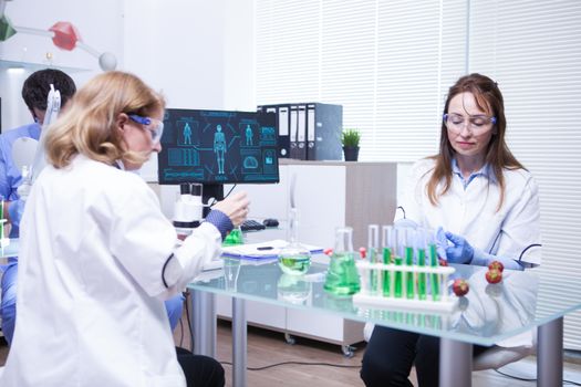Team of different ages of scientist team in a research lab. Quality inspection.