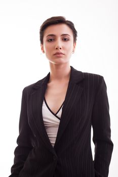 Beautiful young woman looking serious at the camera wearing a black jacket over white background. Fashion model.
