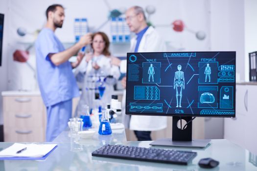 Advanced human body research displayed monitor in laborator. Researchers in human health.