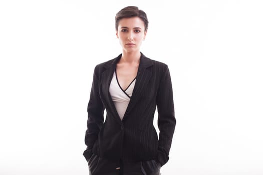 Attractive young girl looking at the camera wearing a black jacket over white background in studio. Stylish female.