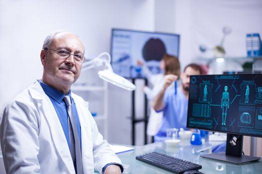 Portrait of senior scientist man looking at the camera in a science laboratory. Research engineer.