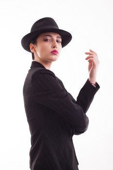 Caucasian beauty wearing a stylish hat posing in studio over white background in studio. Glamorous young female.