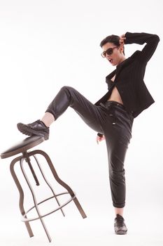 Stylish fashion model screaming while posing in studio dressed casually over white background. Stylish model.