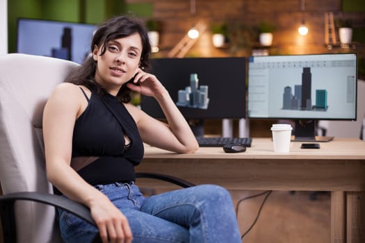 Portrait of beautiful young woman smiling to the camera in her office. Business owner.