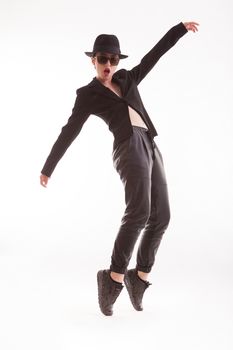 Fashion model posing like Michael Jackson in studio looking at the camera over white background. Stylish jacket.