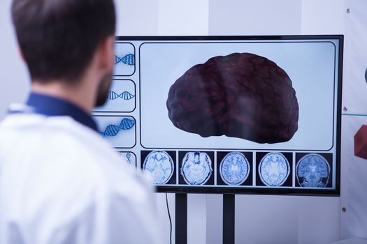 Young doctor checking a brain after nerve surgery. Brain with severe problems.
