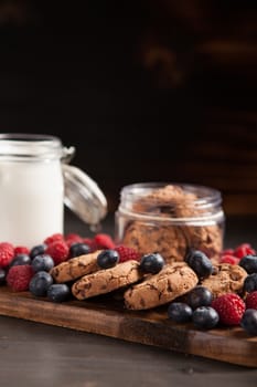 Breakfast ready to be served made out of tasty chocolate chips, milk and fresh bluebarries. Delicious cookies.