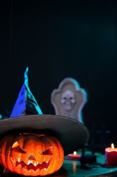 Creepy halloween pumpking with a witch hat on top. Spooky pumpking.