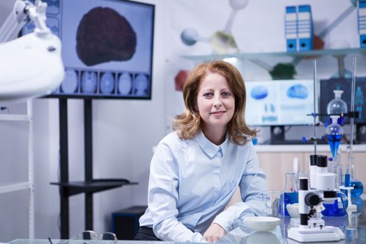 Portrait of middle age woman in a scientist laboratory. Female technician.