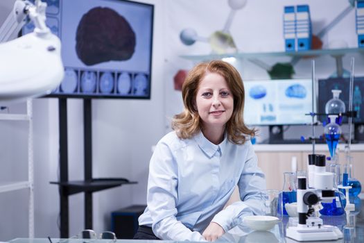 Portrait of middle age woman in a scientist laboratory. Female technician.