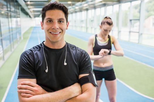 Fit couple on the indoor track at the gym