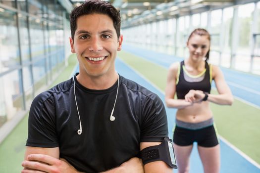 Fit couple on the indoor track at the gym