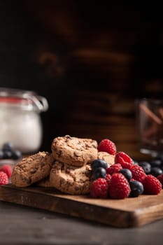 Photo of delicious raspberries with tasty chocolate chips. Homemade snak.