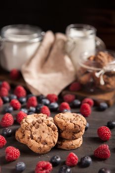 Delicious chocolate chips gouped in a pile with raspberries. Delicious pastry. Breakfast idea.